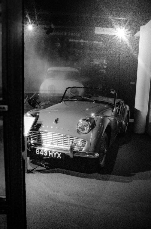 A Triumph behind showroom glass, after hours