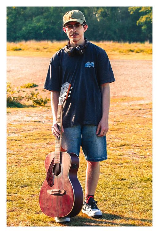 Standing in a field with a guitar
