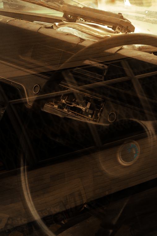 A dashboard through the windscreen, sun across it