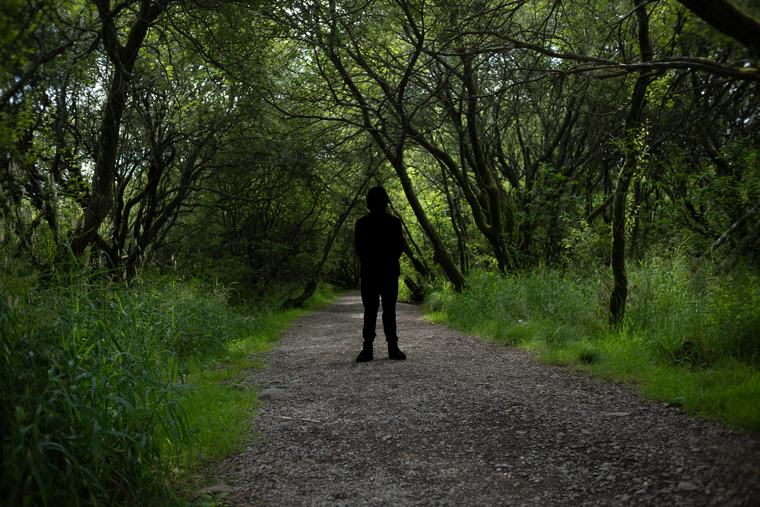 A green tunnel with one figure in it