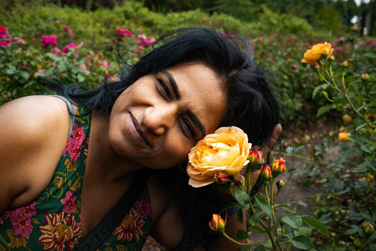 A rose, and someone leaning into it