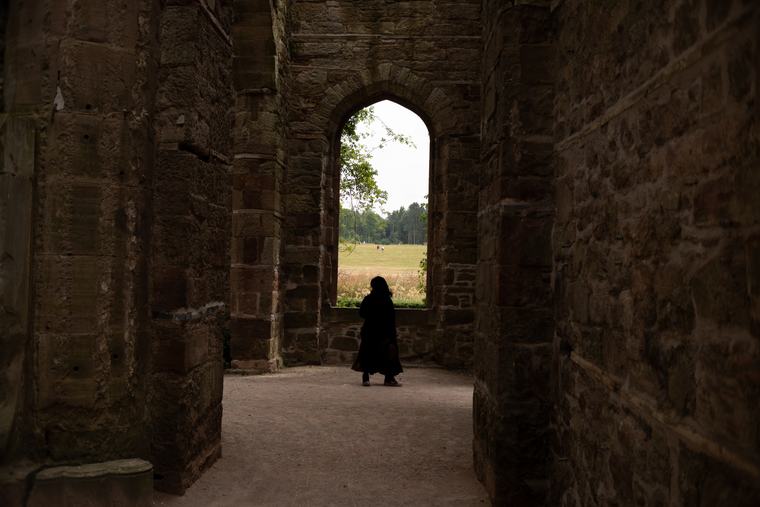 An arch, and somebody standing in it