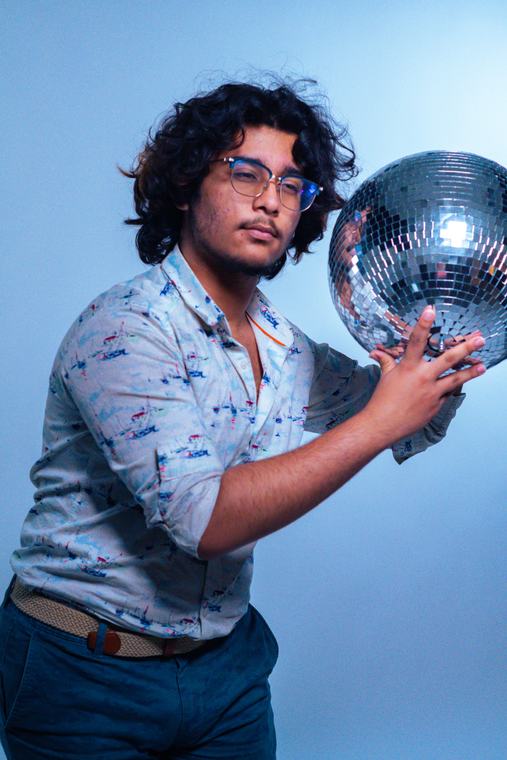 A mirrorball, held like it weighs something